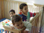 f1 Three kids playing in 1 crib.jpg (33616 bytes)